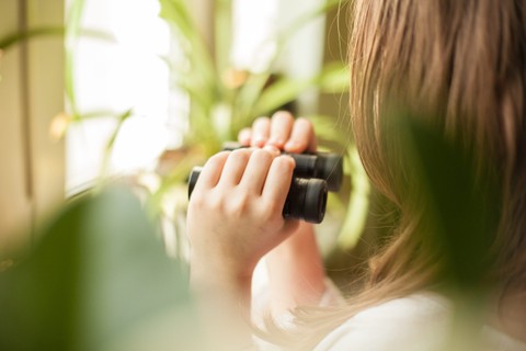 Woman looking through binoculars
