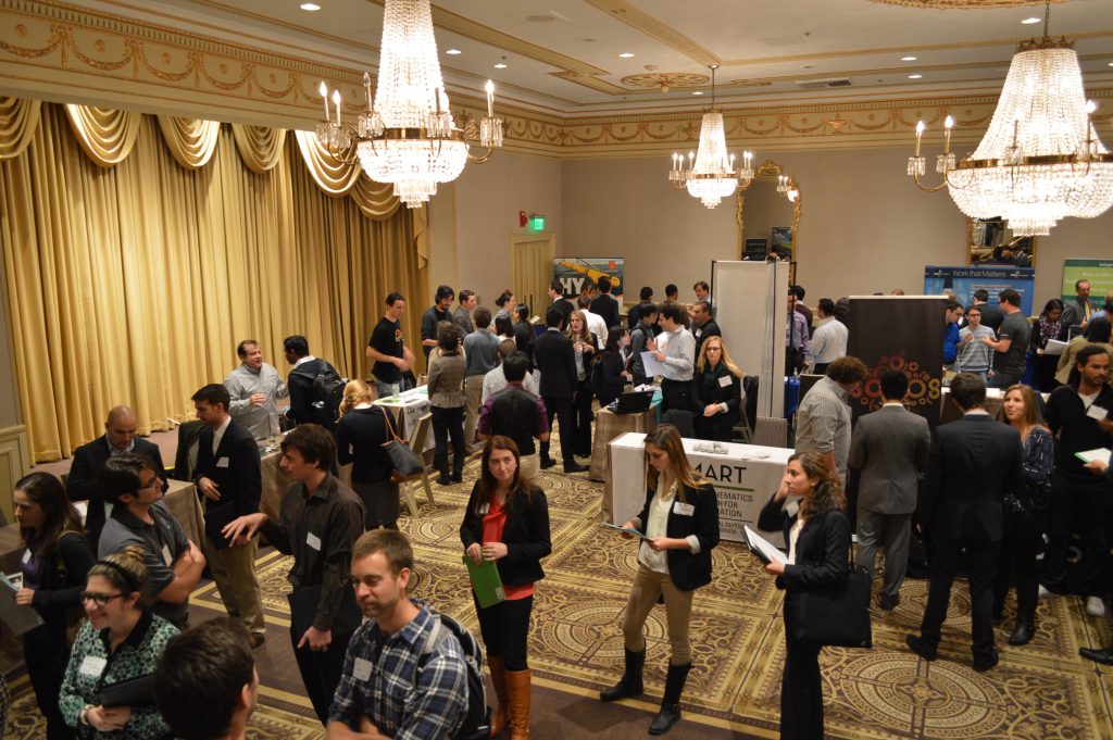 Picture of a past Engineering Career Fair Collaborative event at the Sheraton Commander ballroom with employer tables and students mingling