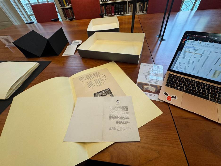 historic papers and a computer on a table